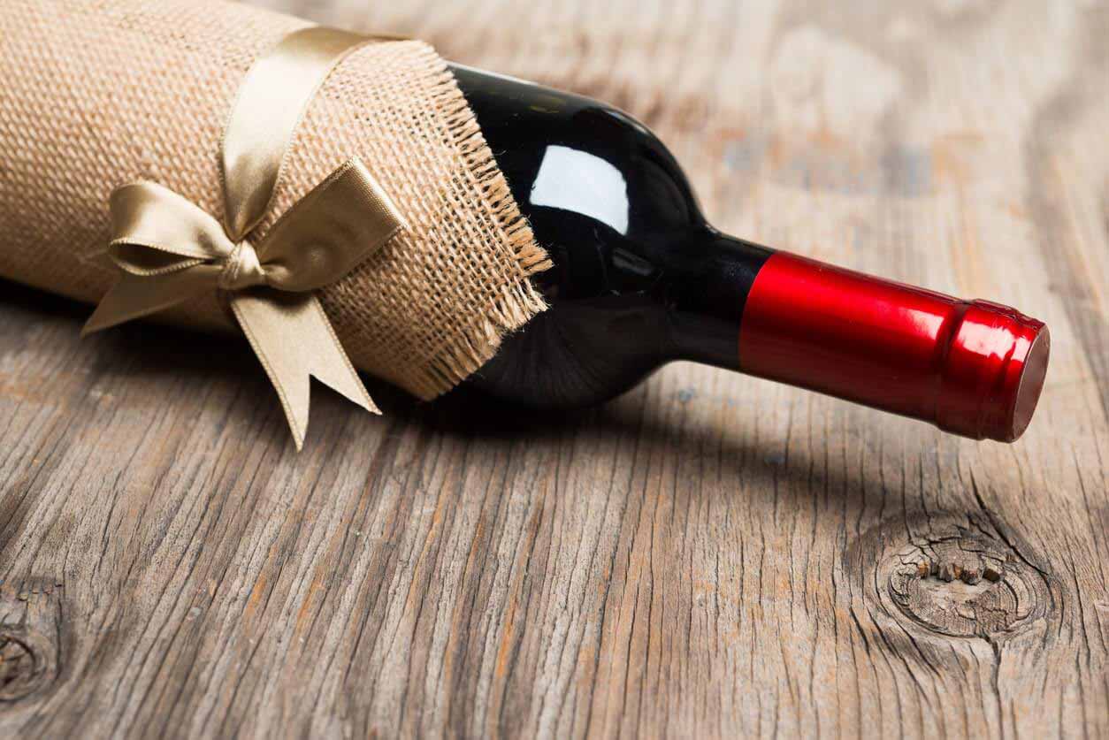 Bottle of red wine wrapped as a gift